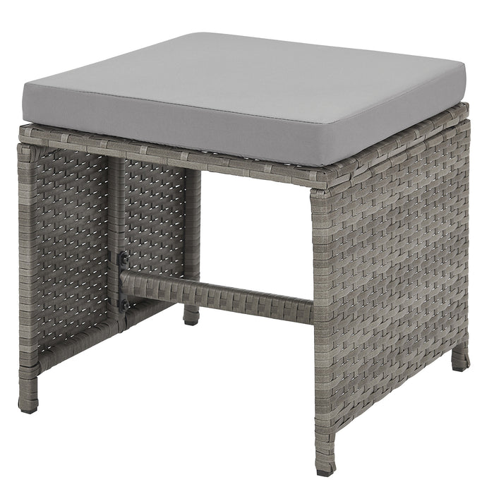 grauer Hocker aus Polyrattan mit grauem Sitzpolster