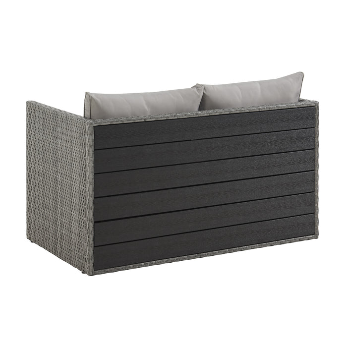 Graues Garten-Sofa mit zwei Rückenkissen aus Rattan von hinten