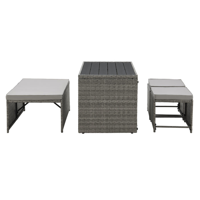 Graues Gartenmöbel-Set aus Rattan mit ausziehbarem Tisch und gepolsterten Sitzbänken Seitenansicht