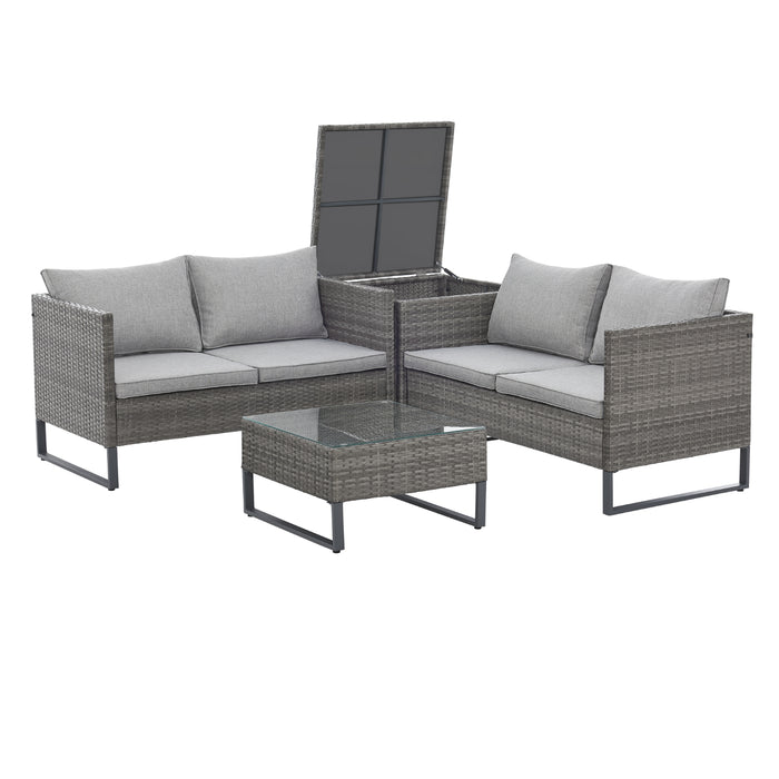 Graue Polyrattan Gartenlounge mit zwei Bänken über Eck gestellt mit offener Kissenbox dazwischen und Tisch