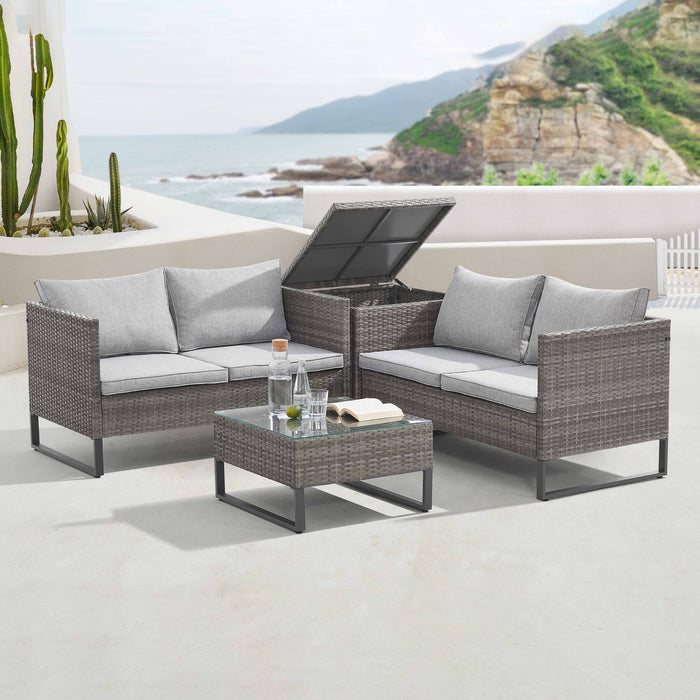 Graue Polyrattan Gartenlounge mit geöffneter Kissenbox auf einer sonnigen Terrasse